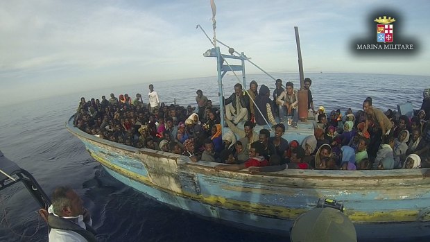 Migrants sit in their boat during a rescue operation off the coast of Sicily earlier this month. 