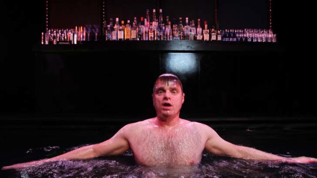 Gasping for breath: Damien Richardson in the pool that is part of the set for <i>The Water Carriers</I>.
