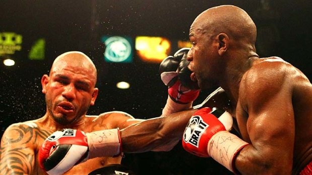 Floyd Mayweather Jr. connects with a right to the face of Miguel Cotto.