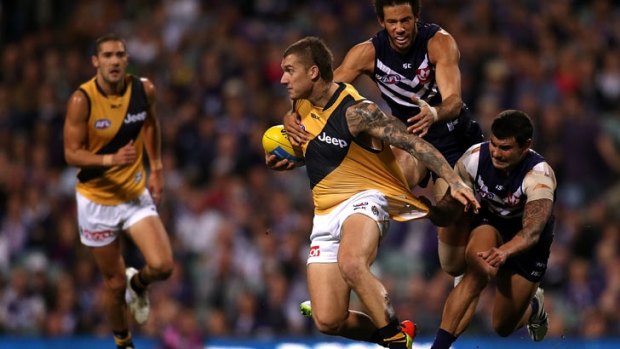 Dustin Martin of the Tigers looks to break from a tackle by Zac Clarke and Clancee Pearce of the Dockers at Domain Stadium on June 5. 