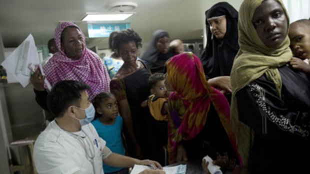 A Chinese doctor interviews Kenyans waiting to receive free  medical attention.