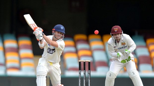 Finding form: David Warner plays a shot during day three of the Sheffield Shield match between Queensland and New South Wales.