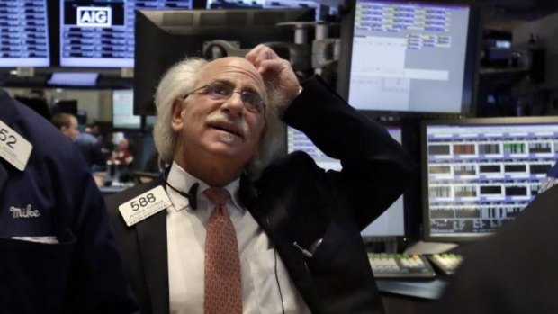 Worrying times ... Trader Peter Tuchman works on the floor of the New York Stock Exchange as markets respond to the crisis in Ukraine.