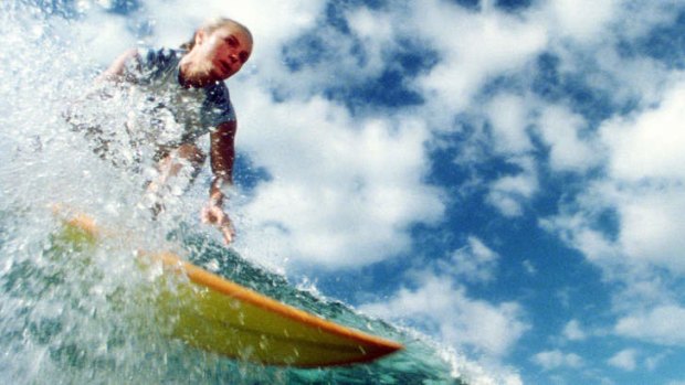 Actress Kate Bosworth rides a wave in a scene from <i>Blue Crush</i>.