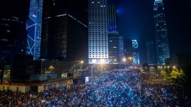 Pro-democracy demonstrators clog the streets of downtown Hong Kong.