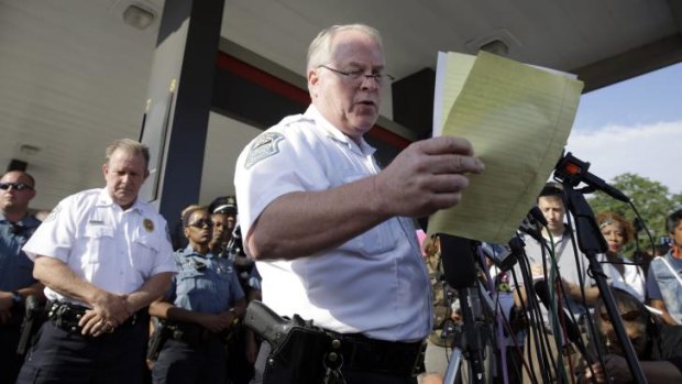 Ferguson Police Chief Thomas Jackson reads a police timeline of events leading up to the police shooting of Michael Brown, which includes the robbery of a local convenience store.