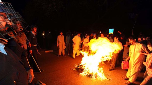 Protests ... Activists of the Pakistani fundamentalist Islamic party Jamaat-i-Islami torch tyres during a demonstration against the release of CIA contractor Raymond Davis.