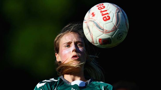 Ellyse Perry heads the ball during a W-League match against Sydney FC.