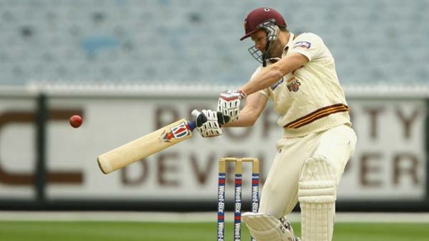 Chris Swan of Queensland plays a flat-batted stroke during his unbeaten 38.