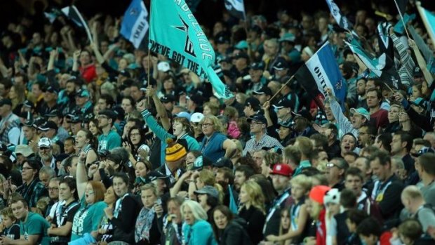 Port fans cheer on their team at the Adelaide Oval on Saturday. The AFL says attendances at the games during the three bye rounds this year are up 30,000 overall compared to the three bye rounds in 2013.