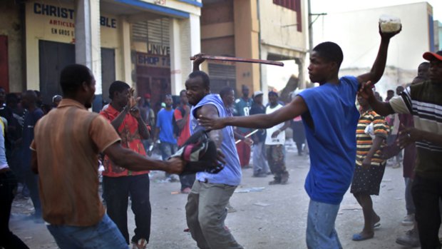 Civil unrest ... Looters fight for goods taken from a destroyed store in Port-au-Prince