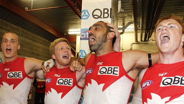 With feeling: Ted Richards, Dan Hannebery, Adam Goodes and Gary Rohan belt out the team song after beating the Cats.