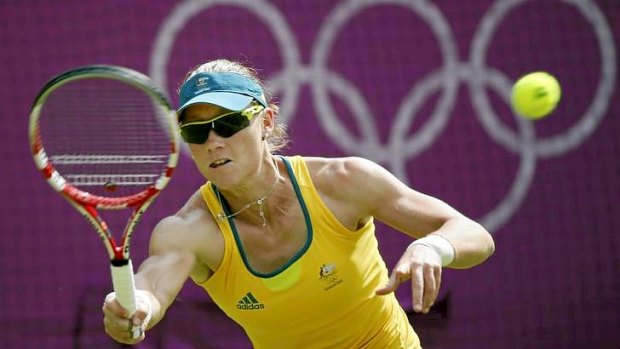 Samantha Stosur hits a forehand during her first round loss in the Olympic tennis singles at Wimbledon.