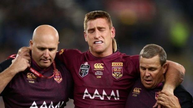 Brent Tate, centre, heads off injured in State of Origin this year.