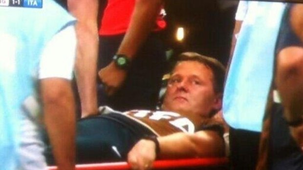 English team physio Gary Lewin being stretchered off field after celebrating a goal.