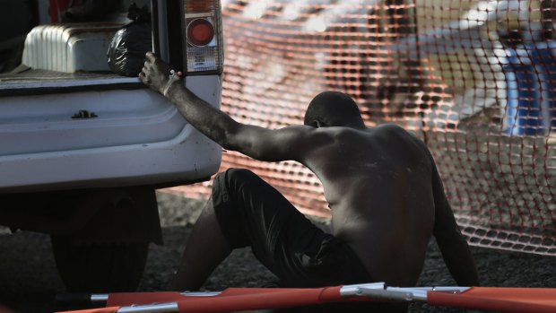 A man too weak to walk arrives at the Medecins Sans Frontieres Ebola isolation and treatment centre in Monrovia, Liberia 