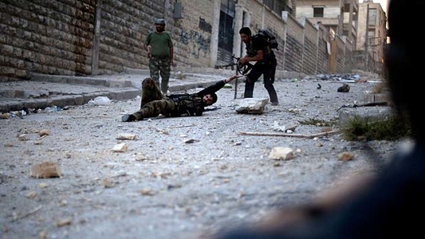 Syrian rebels run to help a wounded comrade after he was shot by a sniper.