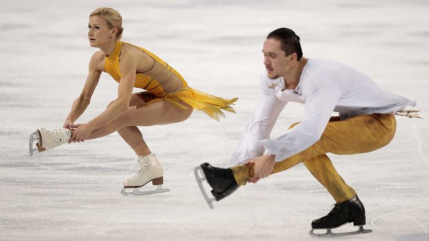 Performing to Jesus Christ Superstar: Russian figure skaters Tatiana Volosozhar and Maxim Trankov win gold in the pairs free skating competition at the Iceberg Skating Palace.