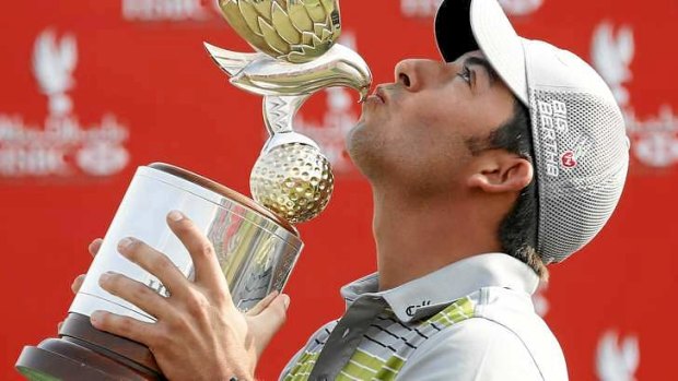 Pablo Larrazabal of Spain kisses his trophy after winning the Abu Dhabi Championship.