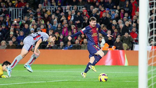 Barcelona's Lionel Messi scores against Osasuna.