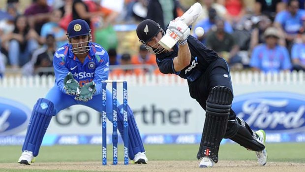 Kane Williamson stays upright to carve a boundary through the covers during his innings of 77.