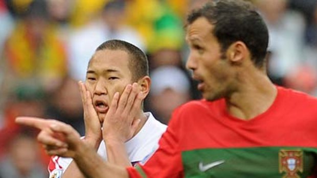 North Korea's striker Jong Tae-Se reacts next to Portugal's defender Ricardo Carvalho.