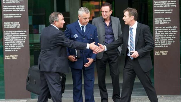 Dr John Jarman (right) shakes the hand of Crown prosecutor Gavin Silbert at the Morwell courthouse yesterday.