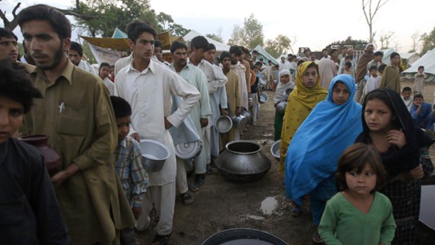 Fleeing the military's offensive in the Swat Valley, these refugees queue for food at the United Nations-run Jalala refugee camp in the north-western district of Mardan.
