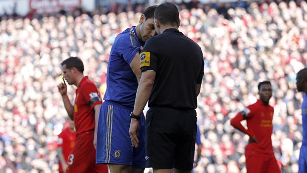 Chelsea's Branislav Ivanovic shows his arm to referee Kevin Friend after the incident.