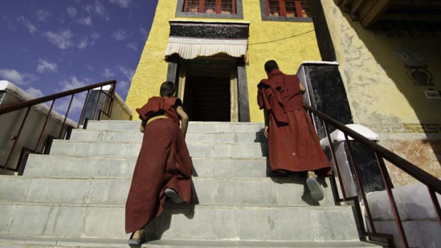 Monks on the staircase at Thikse Monastery.