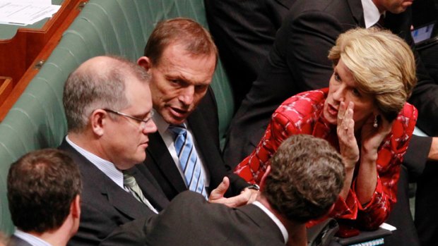Opposition Leader Tony Abbott with his deputy, Julie Bishop, and immigration spokesman Scott Morrison in Parliament yesterday.