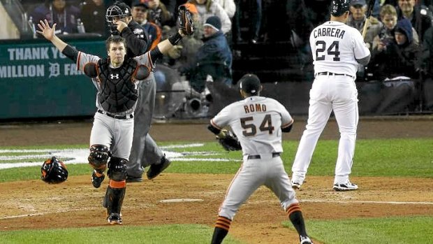 Buster Posey (L) celebrates with teammate Sergio Romo after the Giants win the World Series.