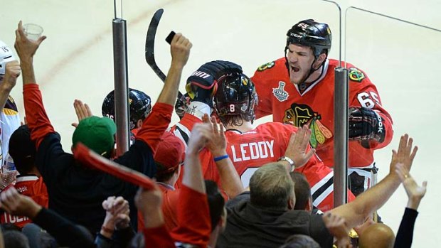 Andrew Shaw #65 of the Chicago Blackhawks celebrates with his teammates after Dave Bolland #36 (not pictured) scored a goal in the third period.