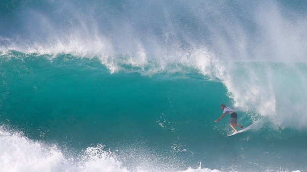 Lots of fun: Australia's Mick Fanning rips through a barrel on the way to winning the final of the Vans World Cup at Sunset Beach in Hawaii.