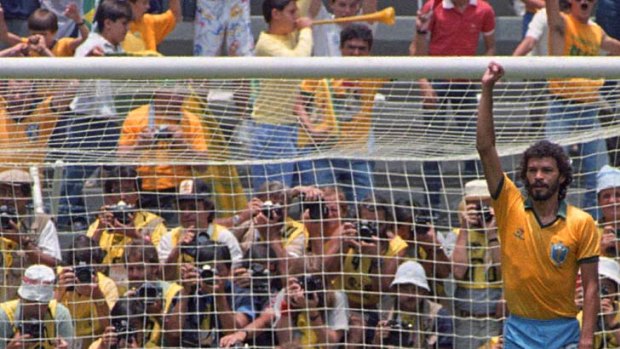 Socrates celebrates after scoring Brazil's first goal against Poland as Polish goalkeeper Jozef Mlynarczyk watches, during a World Cup soccer match in Guadalajara in 1986.