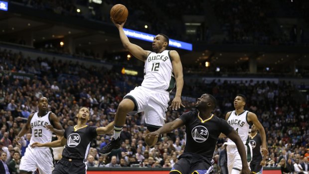 The streak is over: Jabari Parker of the Milwaukee Bucks drives to the hoop against the Golden State Warriors in their 108-95 win.