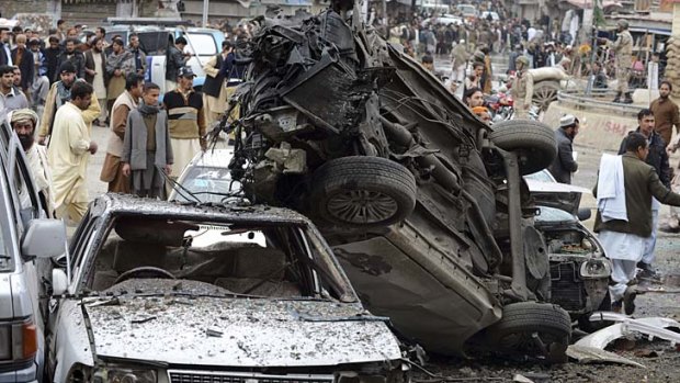 No sanctuary: Onlookers at the site of a bomb explosion in Quetta, on the western border of Pakistan, which killed 11 people and wounded dozens more.