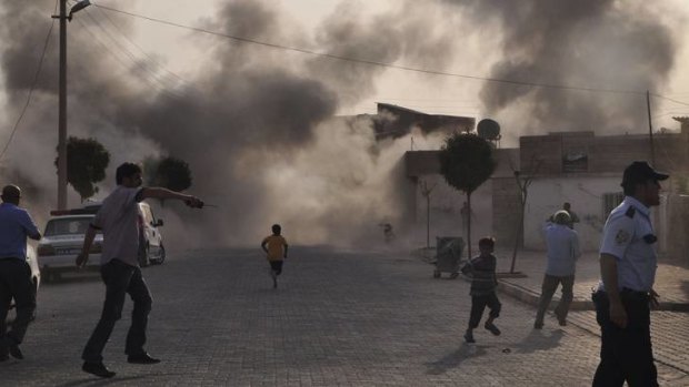 Smoke rises over the streets after an mortar bomb landed from Syria in the border village of Akcakale, Turkey, on Wednesday.