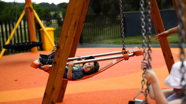 Owen  Smith, 2, enjoys the swing at Boundless Canberra playground.