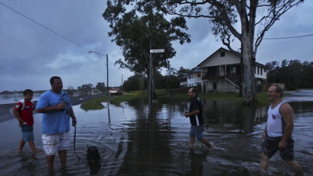 Braced for more rain ... Tweed Heads residents wander the flooded roads.