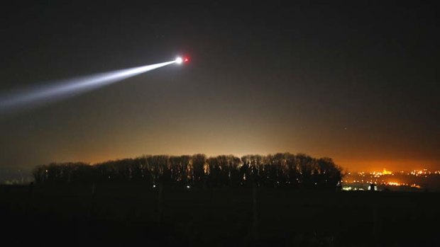 A helicopter flies before a dawn service to mark the 98th ANZAC commemoration ceremony at the Australian National Memorial at Villers-Bretonneux, in northern France.
