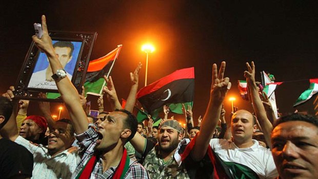 Overjoyed ... anti-government Libyans in Benghazi celebrate reports of the death of Muammar Gaddafi's youngest son.