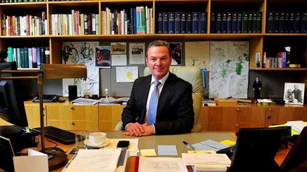 Feet under the desk: Education Minister Christopher Pyne, in his Parliament House office on Friday, will take a hands-on approach to his portfolio.