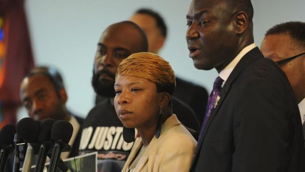 Lesley McSpadden, mother of slain 18 year-old Michael Brown speaks next to Mr Brown's father, Michael snr (left) and their lawyer Benjamin Crump.