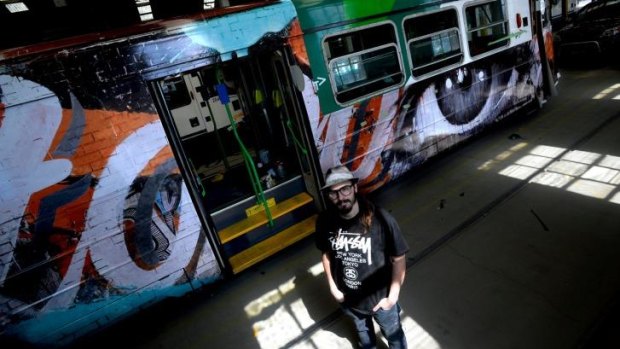 Art on the move: Rone stands in front of a tram he decorated.