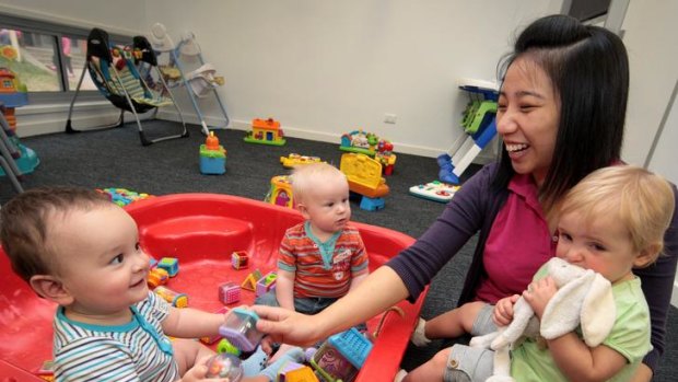 Samuel Bishop, 1 year, and Archer Hughes-Maher, 8 months, play with Betty Lam and Ruby Lendrum, 16 months, at the Baringa Child Care Centre.
