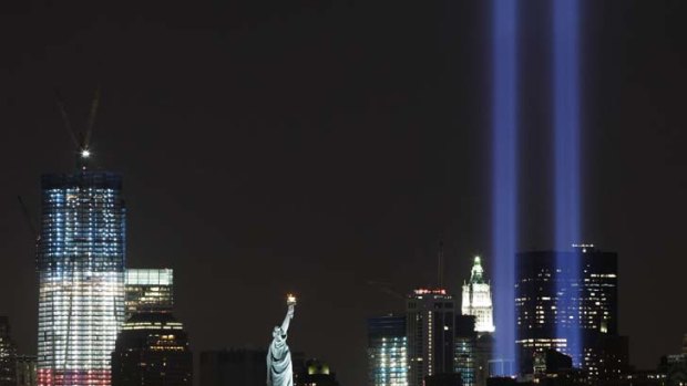 The Tribute in Light shines above lower Manhattan, the Statue of Liberty and One World Trade Centre the night before the 10-year anniversary of the attacks.