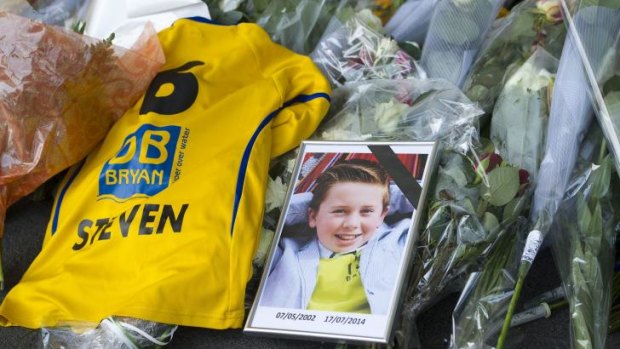 A picture of MH17 victim Steven Noreilde, from Brasschaat, Belgium lays next to a soccer shirt with his name on it at Schiphol airport in Amsterdam.  