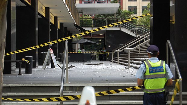 Police have cordoned off the forecourt at the Suncorp building after a large concrete slab fell 10 storeys to the ground.