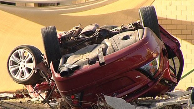 The wreckage of the Ford Falcon involved in the chase.
